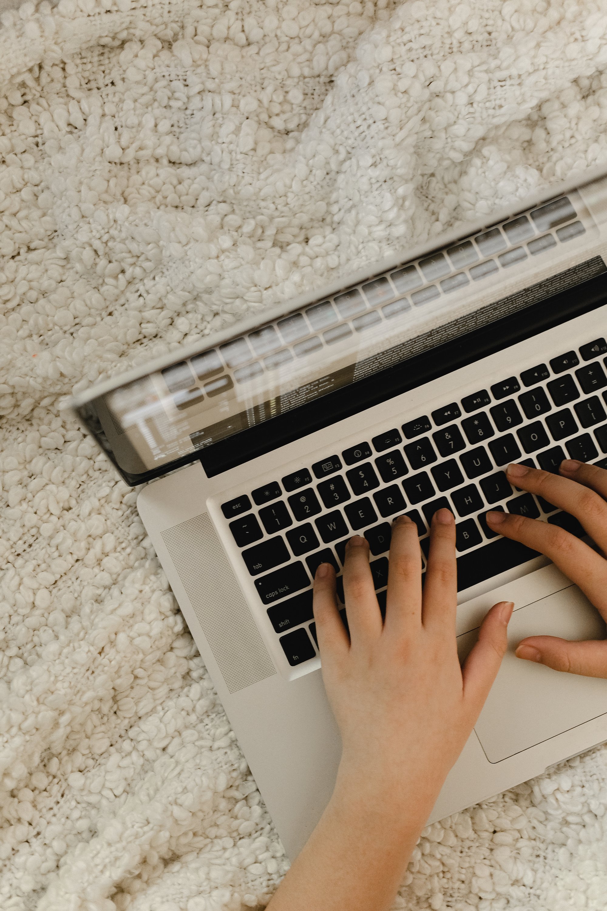 Person Typing on a Laptop